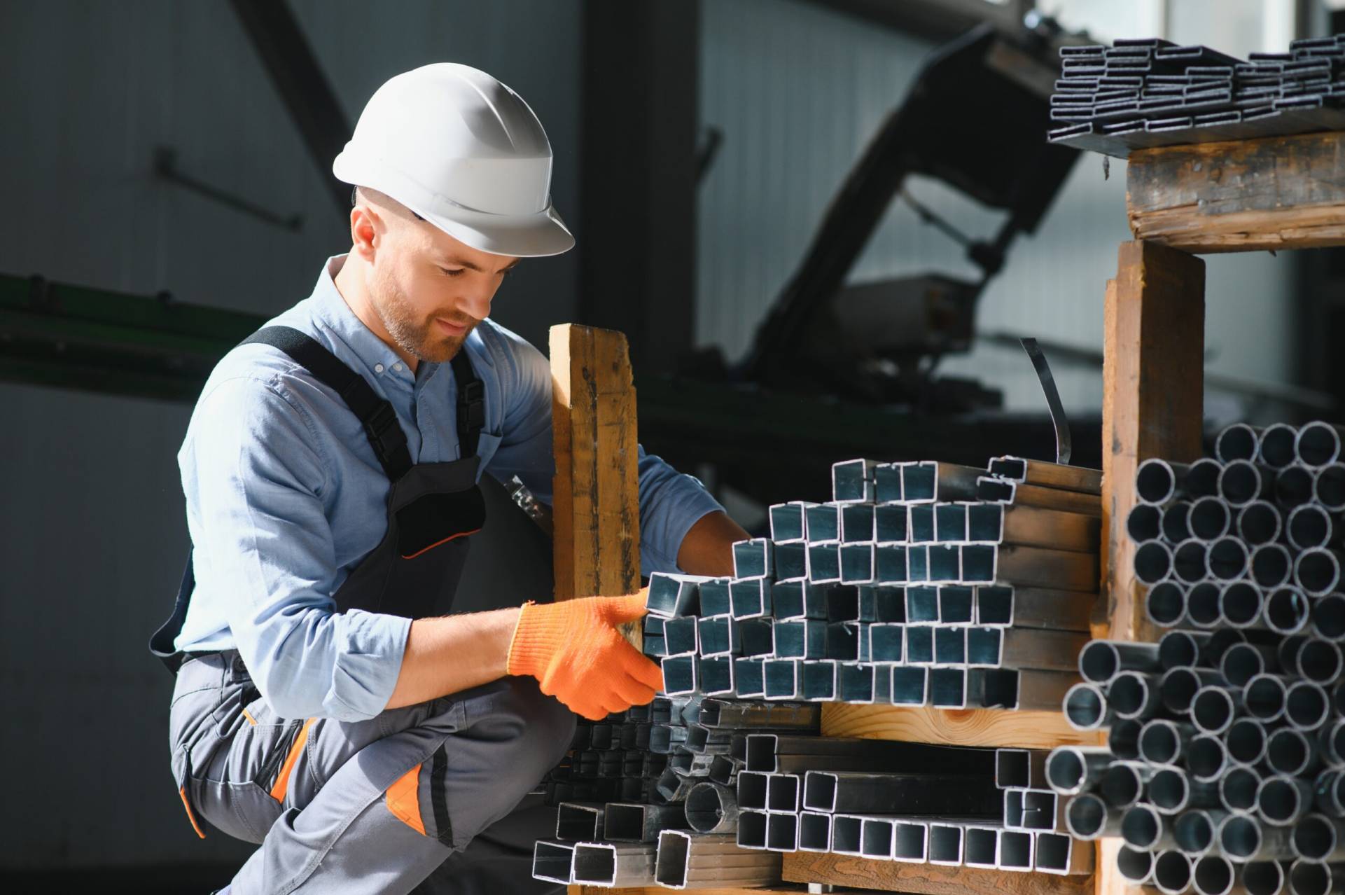 Portrait Factory Worker Protective Uniform Hardhat Standing By Industrial Machine Production Line People Working Industry 2 Scaled